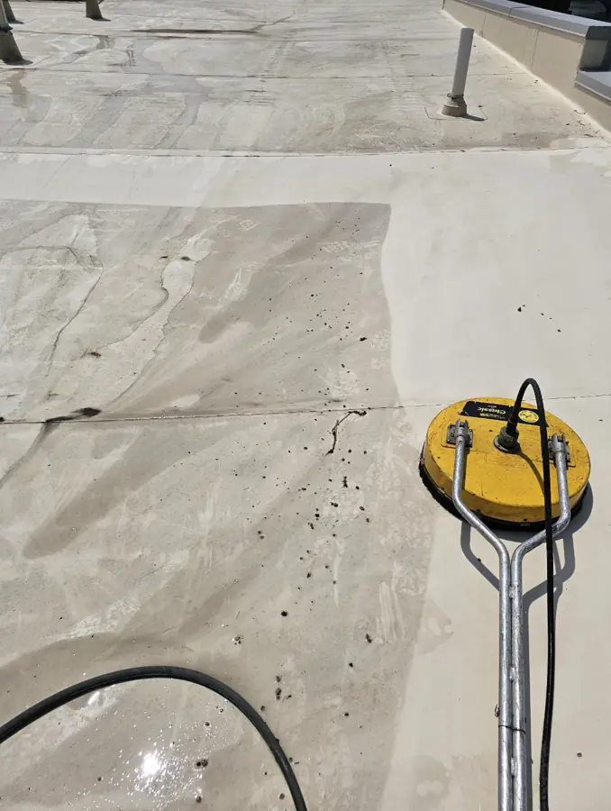 Commercial flat roof membrane cleaning showing clean and dirty sections