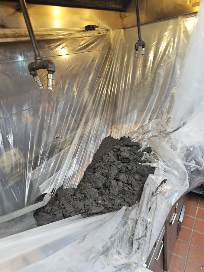 Grease removed from restaurant hood during cleaning